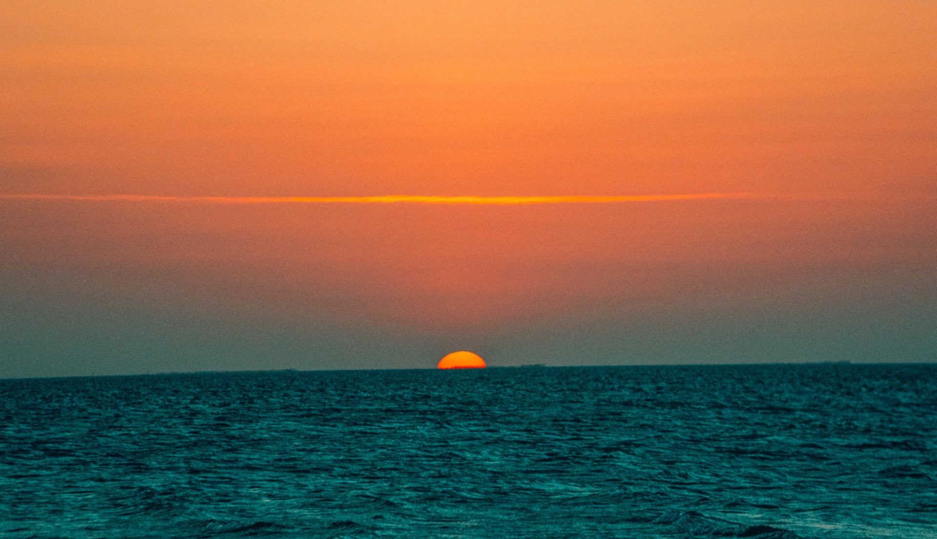 Pôr do sol sobre o mar de água plana na Ilha do Guajiru